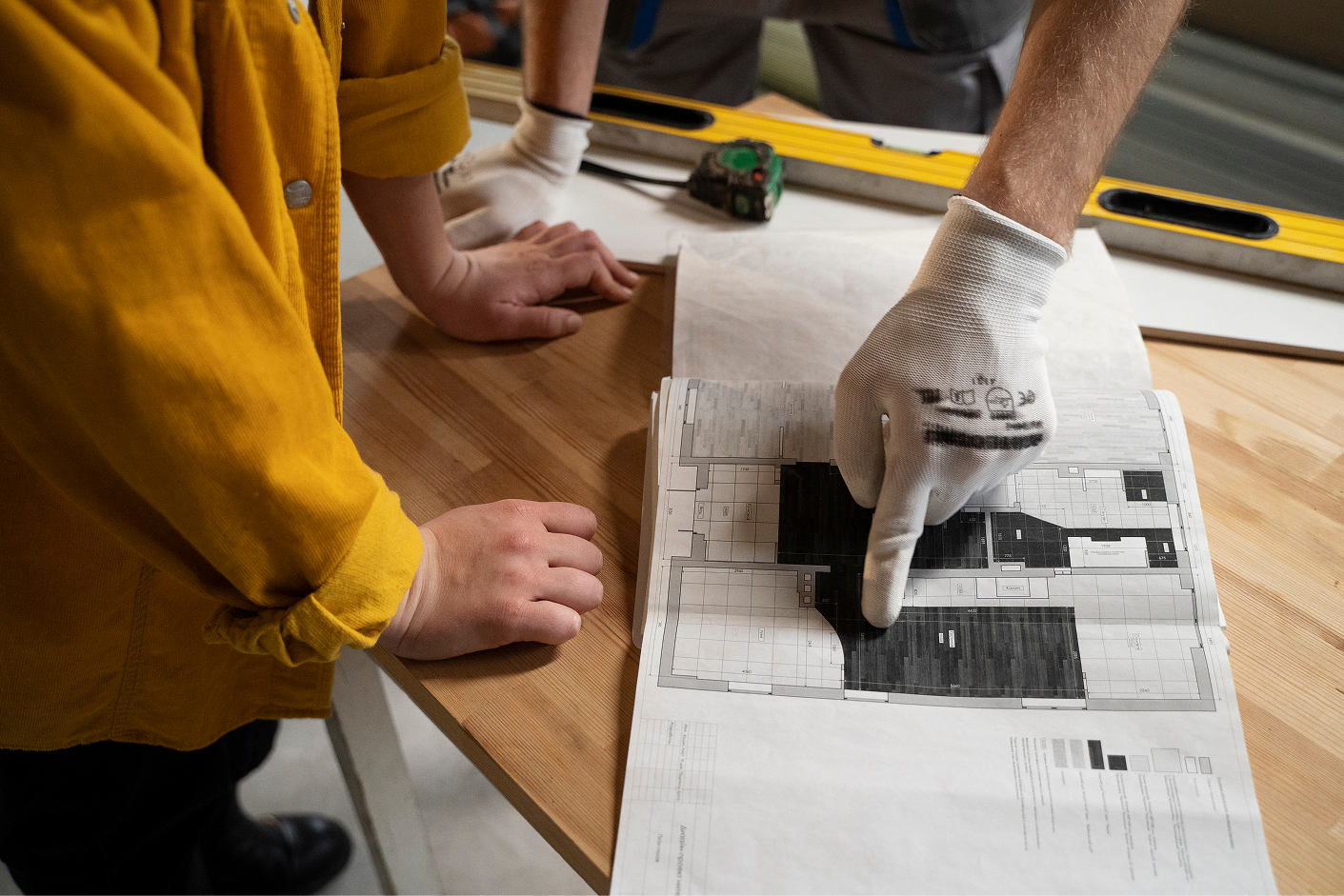 Renovation planning discussion over an apartment floor plan