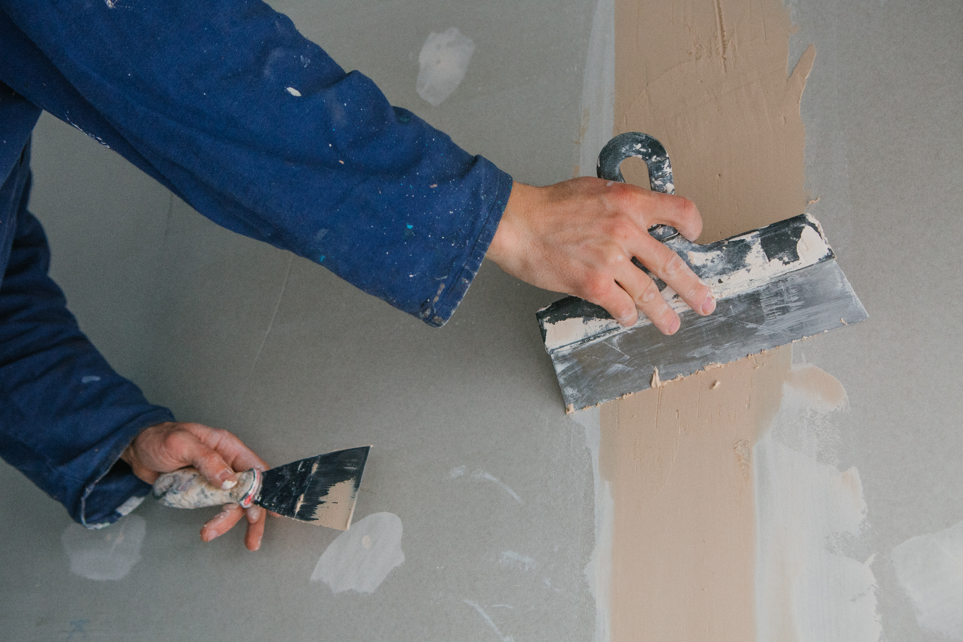Craftsperson applying plaster during wall preparation