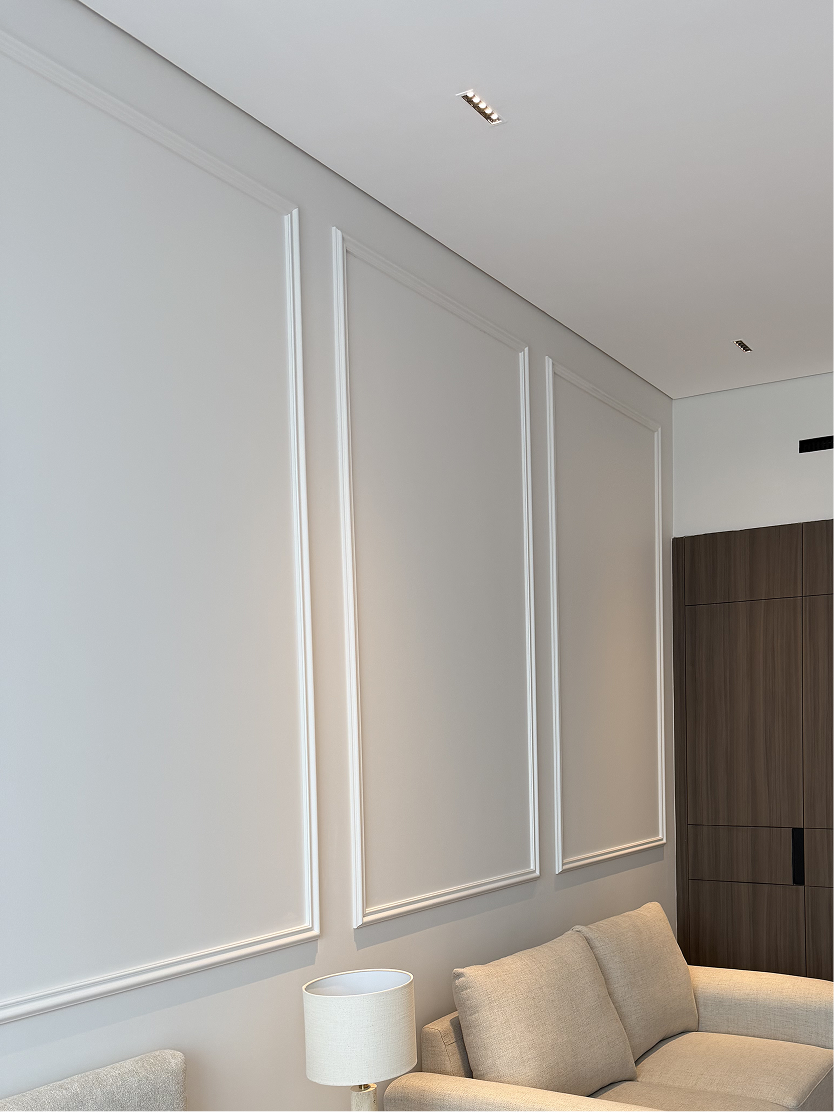 Completed wall mouldings and fitted joinery showing refined finishing details